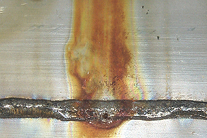 Pitting associated with scale on a 304 stainless steel weld.